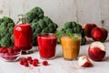 Healthy drinks. raspberry fresh smoothie in glass and bottle and peach juice on white wooden background Royalty Free Stock Photo