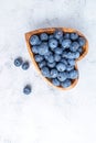 Healthy eating antioxidant blueberries in a wooden bowl heart shaped top view Royalty Free Stock Photo