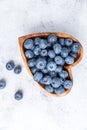 Healthy eating antioxidant blueberries in a wooden bowl heart shaped top view Royalty Free Stock Photo