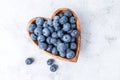 Healthy eating antioxidant blueberries in a wooden bowl heart shaped top view Royalty Free Stock Photo