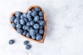 Healthy eating antioxidant blueberries in a wooden bowl heart shaped top view Royalty Free Stock Photo