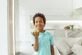 Healthy eating, childhood, nutrition concept. Small boy eating green apple indoor Royalty Free Stock Photo