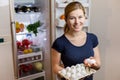 Healthy Eating Concept. Diet. Beautiful Young Woman near the Fridge with eggs. healthy food. Fruits and Vegetables in Royalty Free Stock Photo