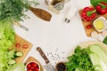 Healthy eating concept - fresh raw green salad, cherry tomatoes, paprika, spinach, cabbage and olive oil on white wood board, top Royalty Free Stock Photo