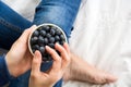 Healthy eating concept. Woman having blueberries in bed. Royalty Free Stock Photo