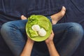 Healthy eating concept. Woman`s hands holding plate with lettuce, avocado slices and poached eggs Royalty Free Stock Photo