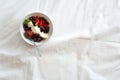 Healthy eating concept. Women`s hands holding bowl with cottage cheese with cream, strawberry, cherry, gooseberry and blueberry Royalty Free Stock Photo