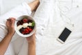 Healthy eating concept. Women`s hands holding bowl with cottage cheese with cream, strawberry, cherry, gooseberry and blueberry Royalty Free Stock Photo