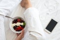 Healthy eating concept. Women`s hands holding bowl with cottage cheese with cream, strawberry, cherry, gooseberry and blueberry Royalty Free Stock Photo