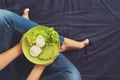 Healthy eating concept. Women`s hands holding plate with lettuce, avocado slices and poached eggs Royalty Free Stock Photo