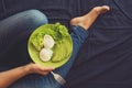 Healthy eating concept. Women`s hands holding plate with lettuce, avocado slices and poached eggs Royalty Free Stock Photo