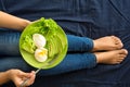 Healthy eating concept. Women`s hands holding plate with lettuce, avocado slices and poached eggs Royalty Free Stock Photo