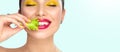 Healthy eating, diet. Beautiful healthy girl eating raw vegan food and smiling. Beauty young fashion woman eats green fresh lettuc Royalty Free Stock Photo