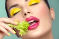 Healthy eating, diet. Beautiful healthy girl eating raw vegan food and smiling. Beauty young fashion woman eats green fresh lettuc Royalty Free Stock Photo