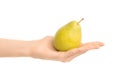 Healthy eating and diet Topic: Human hand holding green pear isolated on a white background in the studio Royalty Free Stock Photo