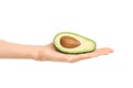 Healthy eating and diet Topic: Human hand holding a half avocado isolated on a white background in the studio Royalty Free Stock Photo