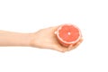 Healthy eating and diet Topic: Human hand holding a half of grapefruit isolated on a white background in the studio Royalty Free Stock Photo