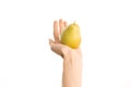 Healthy eating and diet Topic: Human hand holding yellow pear isolated on a white background in the studio, first-person view Royalty Free Stock Photo