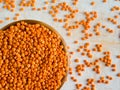 Healthy eating and dietary. Bowl of raw red lentil on white wooden background. Top view. Flat lay. Masoor Dal or Canadian Orange