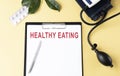 HEALTHY EATING on the Document with yellow background. Healthcare
