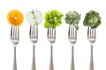 Healthy eating: five iron fork with fruit and vegetable, on white