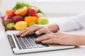 Dietitian typing treatment to patient via internet