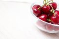 Cherries in glass dish. Cherry on wood and white background. - healthy eating and food concept Royalty Free Stock Photo