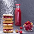 Oat cookies with raspberry, honey, soft cheese and raw raspberry and red juice in glass bottle , close up Royalty Free Stock Photo