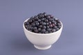 Healthy eating, food, dieting and vegetarian concept - fresh, ripe blueberries in bowl, wild berry, closeup. Fresh blueberry on gr