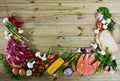 Raw beef, salmon and vegetables on wooden background Royalty Free Stock Photo