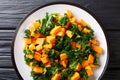 Healthy eating fried sweet potatoes with cabbage kale close up on a plate. Horizontal top view