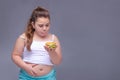 Healthy eating, glutton, bad nutritional habits, overeating, fast food, overweight. baby girl with excess weight keeps the stomach Royalty Free Stock Photo