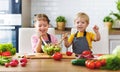 Healthy eating. Happy children prepares vegetable salad in kitc Royalty Free Stock Photo