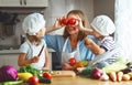 Healthy eating. Happy family mother and children prepares veget Royalty Free Stock Photo