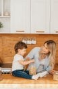 Healthy eating. Happy family mother and children prepares vegetable salad in kitchen Royalty Free Stock Photo