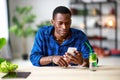 Healthy eating. happy young black man eating salad with phone and tablet pc in morning Royalty Free Stock Photo