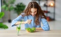 Healthy eating. happy young girl eating salad in morning in kitchen Royalty Free Stock Photo