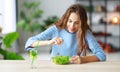 Healthy eating. happy young girl eating salad in morning in kitchen Royalty Free Stock Photo