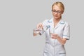 Healthy eating or lifestyle concept - female woman doctor holding and a glass of clear fresh water Royalty Free Stock Photo