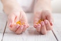 healthy eating, medicine, health care, food supplements and people concept - close up of woman hands holding pills or fish oil ca Royalty Free Stock Photo