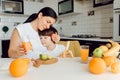 Healthy Eating. mom with baby eating fruits in the kitchen Royalty Free Stock Photo