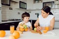 Healthy Eating. mom with baby eating fruits in the kitchen Royalty Free Stock Photo