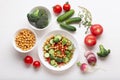 Healthy eating plate. Vegan salad with vegetables and chickpeas, various raw vegetables on white. Royalty Free Stock Photo