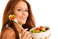 Healthy eating - woman eats a bowl of greek salad isolated over Royalty Free Stock Photo