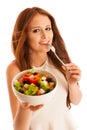 Healthy eating - woman eats a bowl of greek salad isolated over Royalty Free Stock Photo