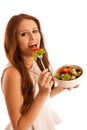 Healthy eating - woman eats a bowl of greek salad isolated over Royalty Free Stock Photo