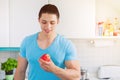 Healthy eating young man eat apple fruit in the kitchen copyspace Royalty Free Stock Photo