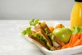 Healthy eco lunch box with a sandwich, fresh vegetables and fruits, a bottle of juice on a light background. School lunch. No Royalty Free Stock Photo