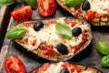 Healthy Eggplant or Aubergine pizza with tomato sauce, mozzarella cheese, basil and olives