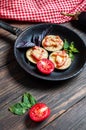 Healthy eggplant with cheese, tomatoes and basil on a pan against rustic wood